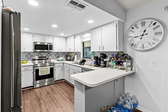 a kitchen with sink a stove and refrigerator