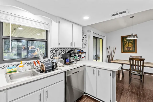 a kitchen with refrigerator and cabinets