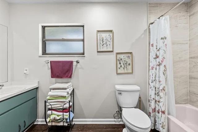 a bathroom with a sink mirror and vanity