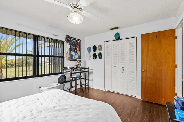a bathroom with a sink a toilet a mirror a vanity and shower