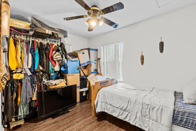 a bedroom with a bed and wooden floor