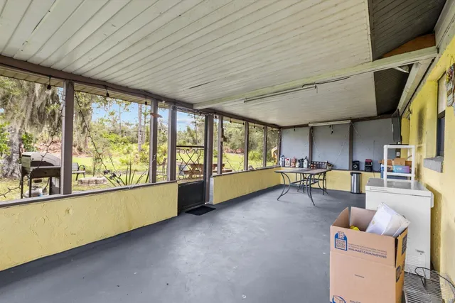 a view of a house with swimming pool and sitting area