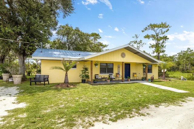 a front view of house with yard and seating area