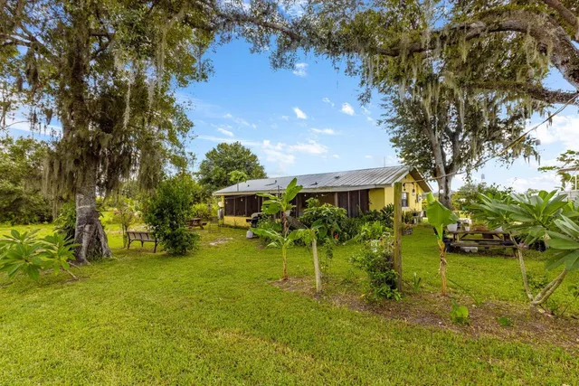 a view of yard with green space and seating area