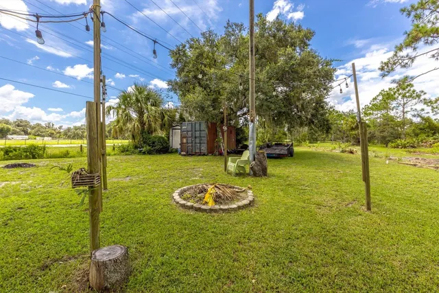 a view of a lake with a house and a yard