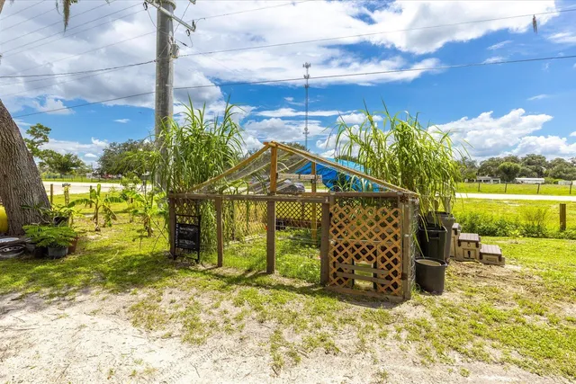 a view of a lake with a house and a yard