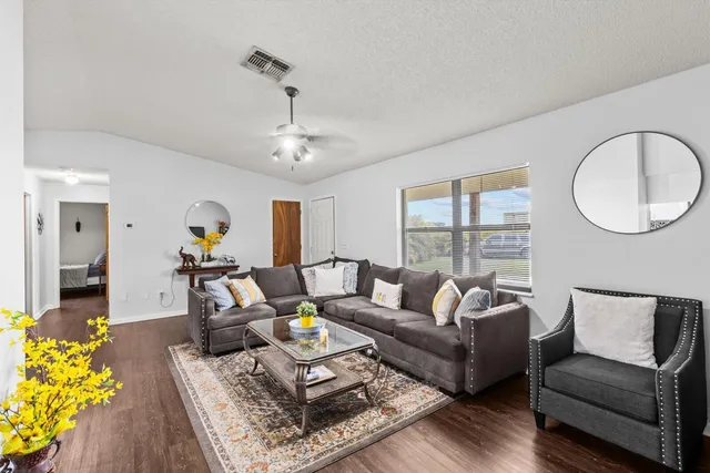 a living room with furniture and wooden floor