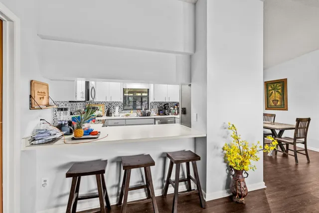 a view of a dining room with furniture and wooden floor