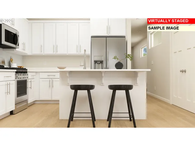 a kitchen with a refrigerator a stove a sink and a dining table with wooden floor