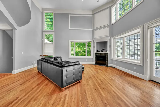 a living room with stainless steel appliances granite countertop a stove top oven a sink and a refrigerator
