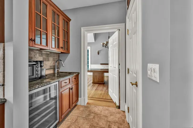a kitchen with stainless steel appliances granite countertop a refrigerator and a stove