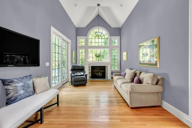 a living room with furniture a fireplace and a flat screen tv