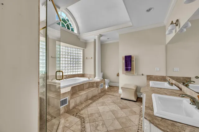 a bathroom with a granite countertop sink and a bathtub