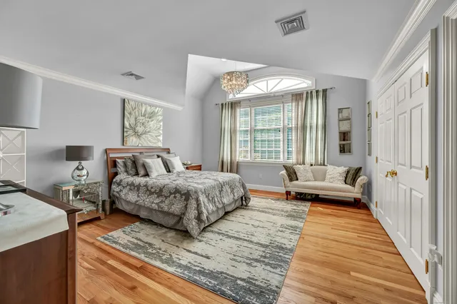 a spacious bedroom with a bed and a couch