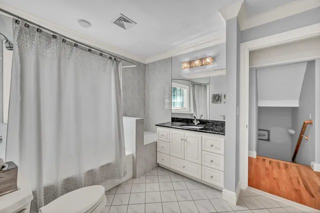 a spacious bathroom with a granite countertop sink mirror and a toilet