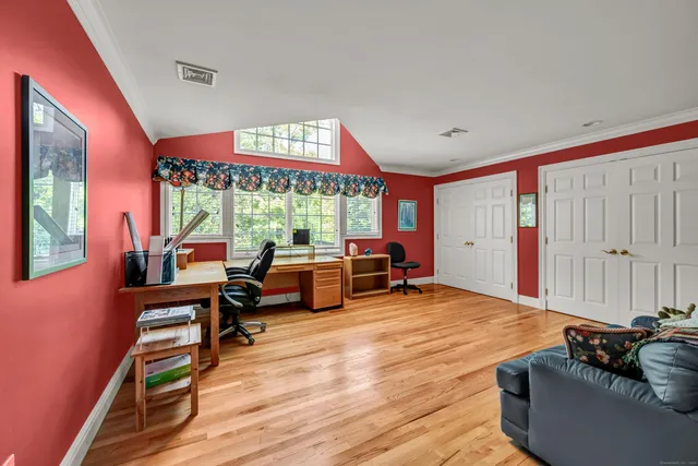 a living room with furniture and large windows