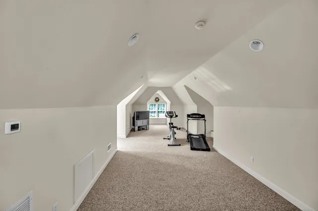 a view of a livingroom with a table and chairs