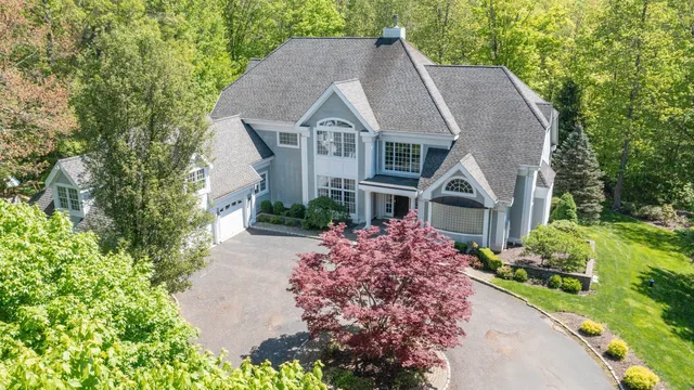 a aerial view of a house next to a yard
