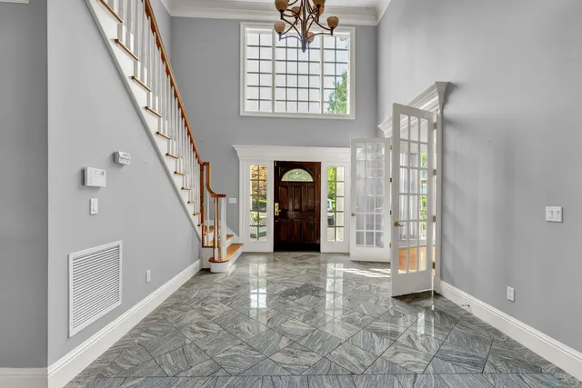 a view of an empty room with fireplace and windows