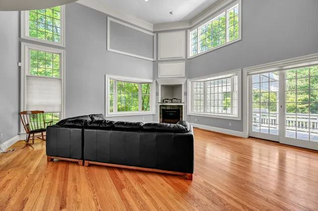 a living room with furniture and large windows