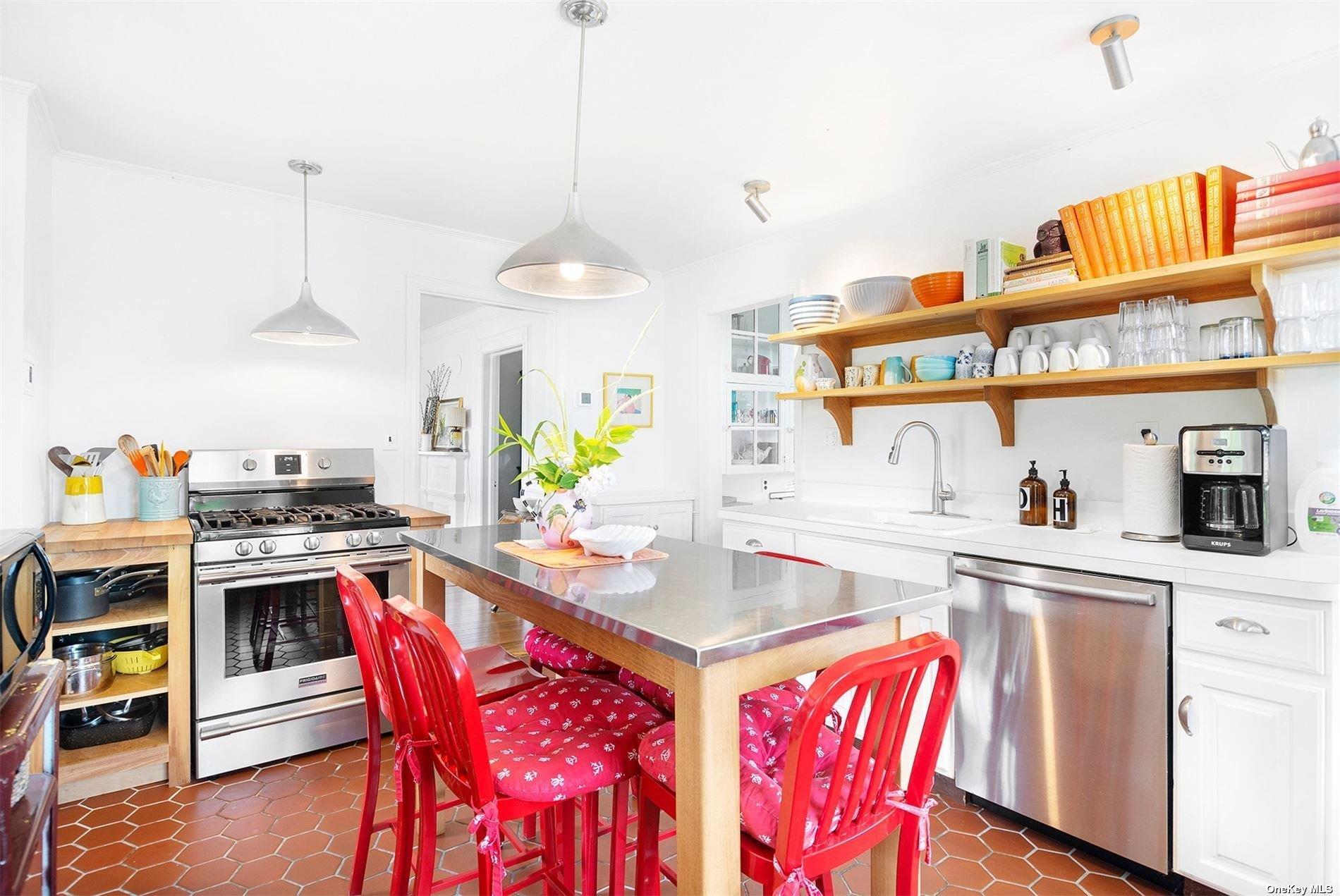 640 Orchard Street New Suffolk, NY 11956 - Photo 13 of 30 a kitchen with stainless steel appliances granite countertop a stove a sink dishwasher a stove a dining table and chairs with wooden floor