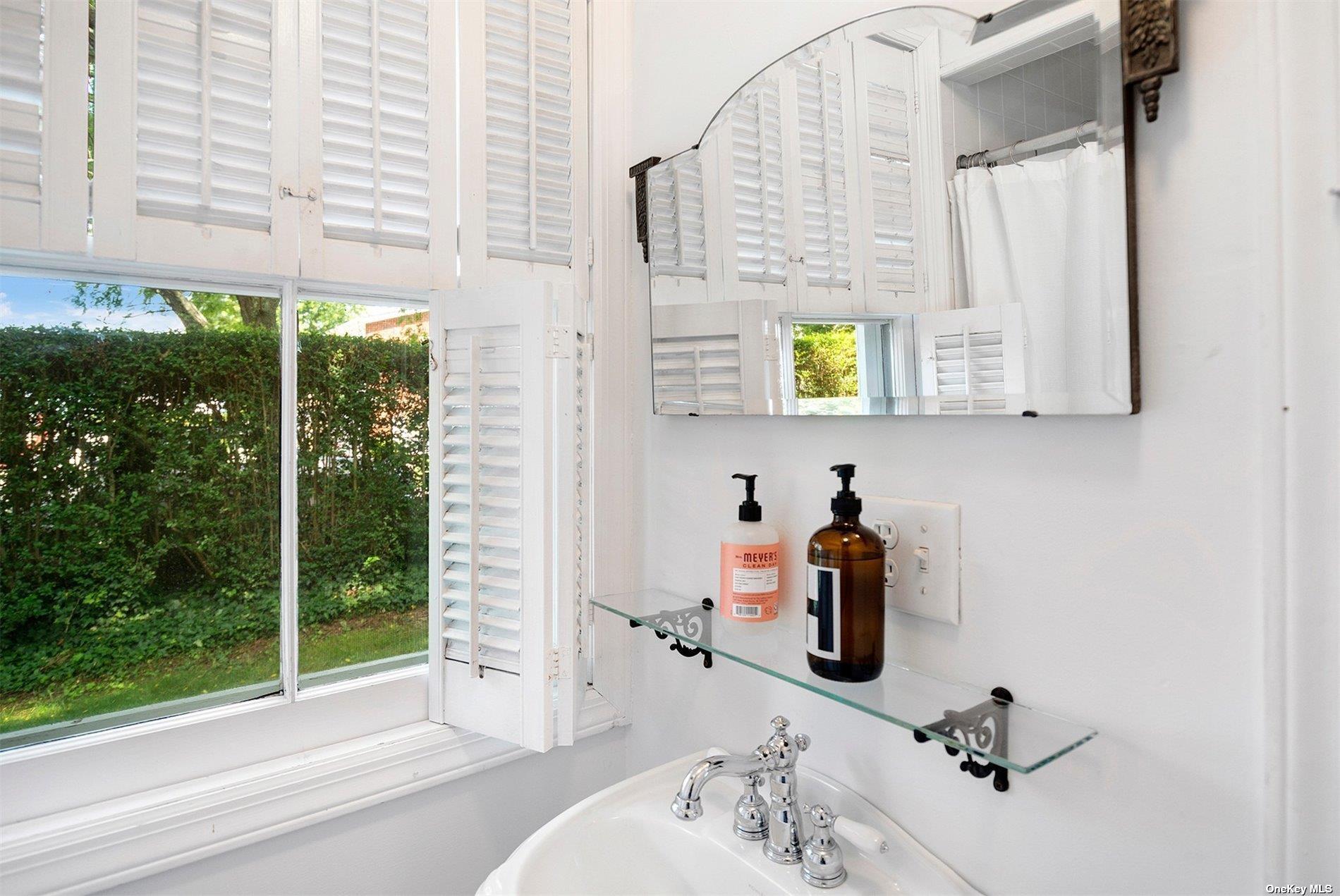 640 Orchard Street New Suffolk, NY 11956 - Photo 14 of 30 a bathroom with a window sink and mirror