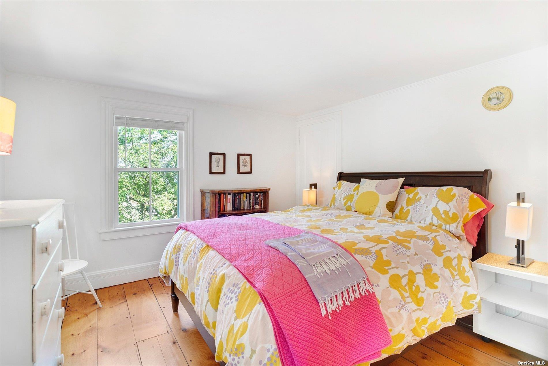640 Orchard Street New Suffolk, NY 11956 - Photo 17 of 30 a bedroom with a bed and a window
