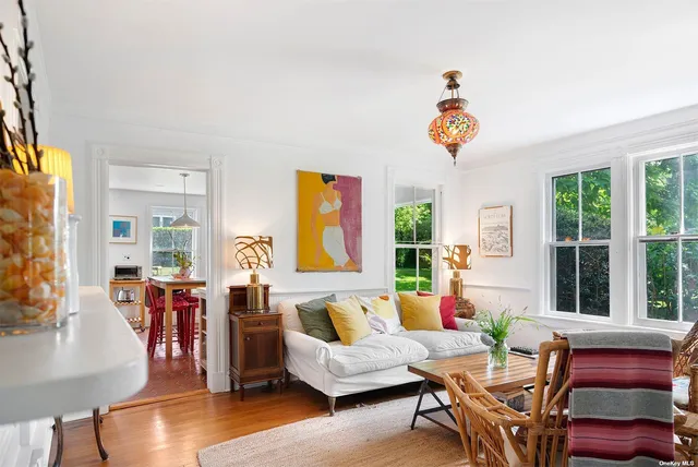 a living room with furniture a wooden floor and a window