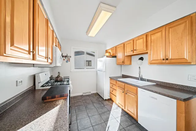 a kitchen with a sink a stove and cabinets