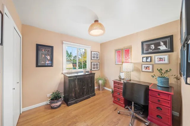 a view of a workspace with furniture and window