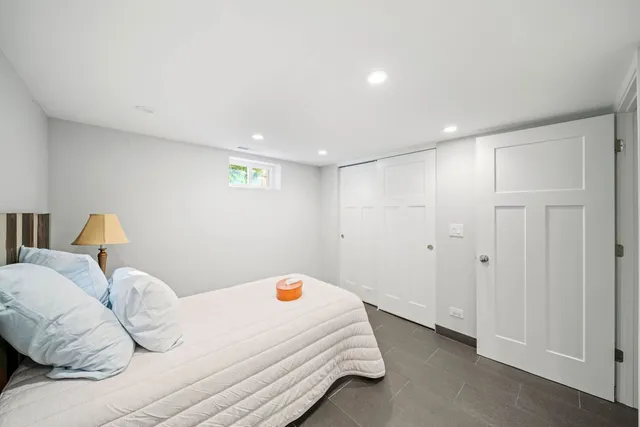 a room with a bed and a lamp