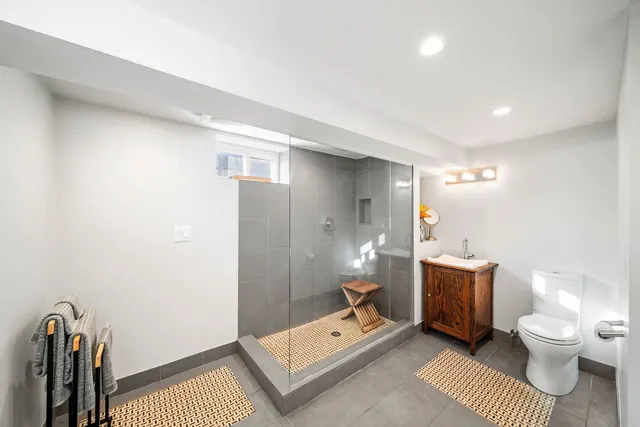 a bathroom with a toilet sink and mirror