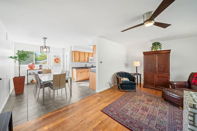 a dining room with furniture and a rug