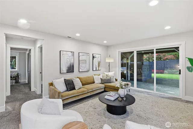 a living room with furniture and a floor to ceiling window