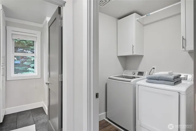a utility room with closet dryer and washer