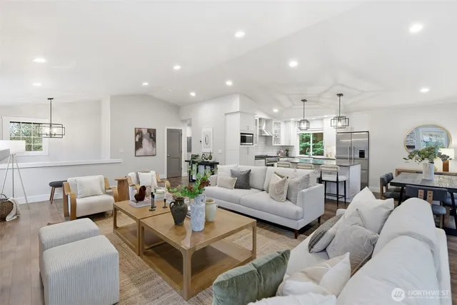 a living room with furniture and a view of kitchen