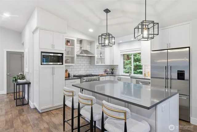 a kitchen with a center island and stainless steel appliances