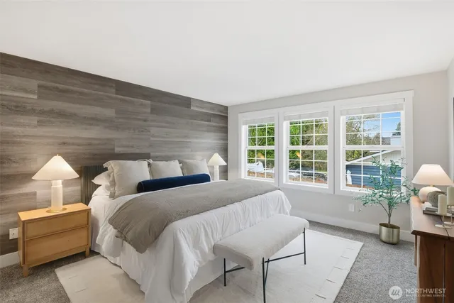 a spacious bedroom with two beds and a window