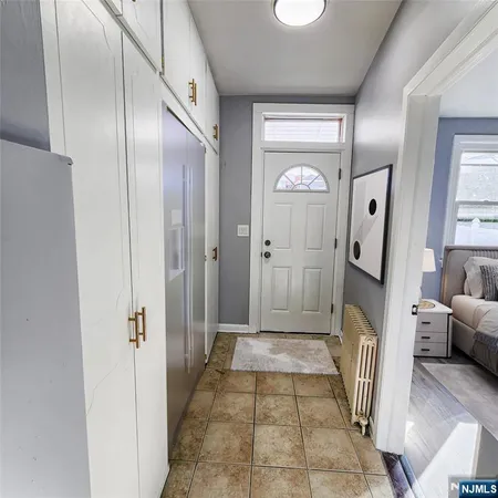 a view of a hallway with a livingroom and a mirror