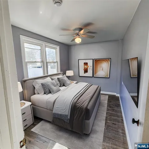 a bedroom with a large bed and a chandelier