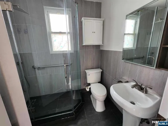 a bathroom with a sink toilet and mirror