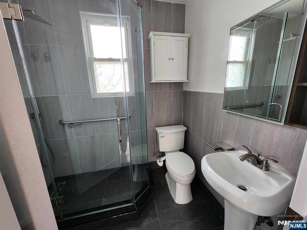 640 Chase Avenue, Unit 2 Lyndhurst, NJ 07071 - Photo 10 of 10 a bathroom with a sink toilet and mirror