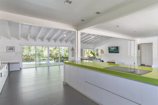 a outdoor space with the couches and dining table with the garden view