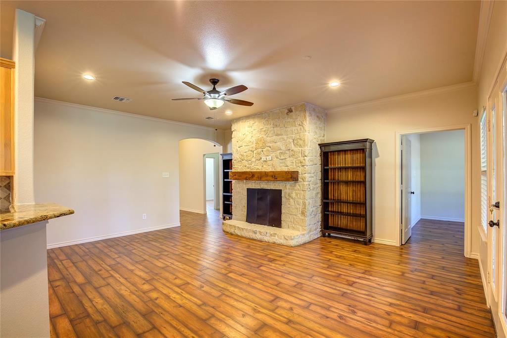 2617 Kirby Road Rowlett, TX 75088 - Photo 5 of 39 Unfurnished living room featuring arched walkways, recessed lighting, a ceiling fan, ornamental molding, and dark wood-type flooring