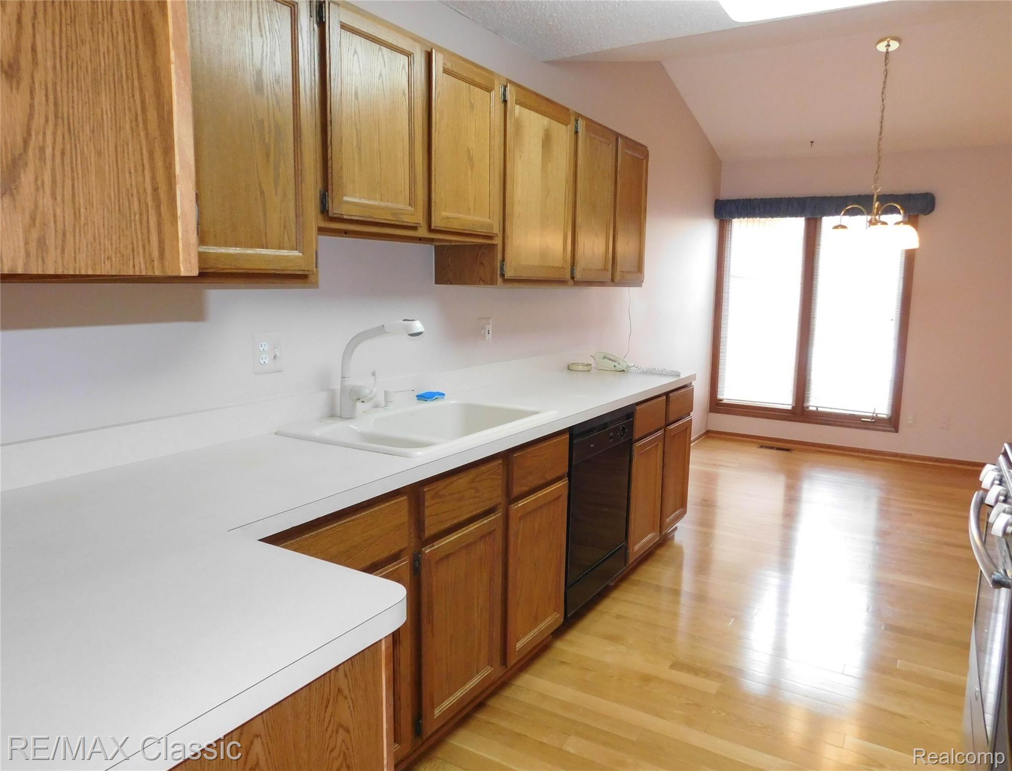 21840 River Ridge Trail, Unit 104 Farmington, MI 48335 - Photo 10 of 35 KITCHEN WITH PLENTY OF COUNTERTOP WORKSPACE AND CABINET STORAGE