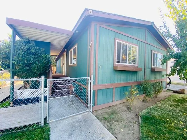 a view of a house with a yard and porch