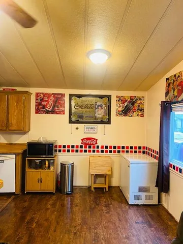 a view of a room with stainless steel appliances kitchen island