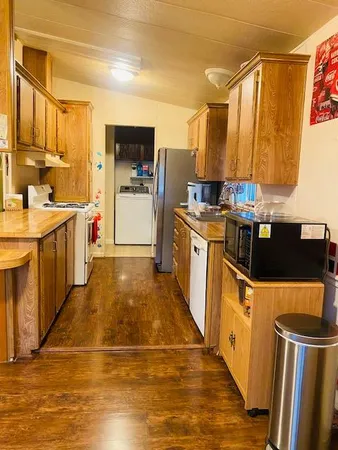 a kitchen with stainless steel appliances granite countertop a refrigerator a stove top oven a sink and dishwasher