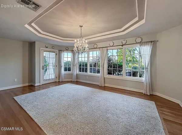 a living room with lots of furniture and wooden floors