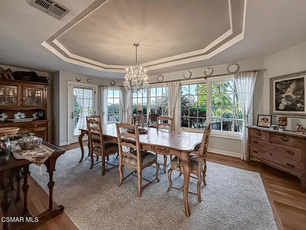 a view of a patio with table and chairs and potted plants